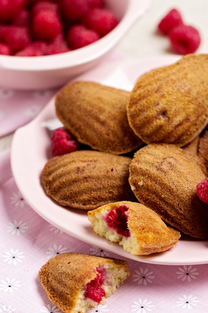 French pastry Madeleine with raspberries. Selective focus.の写真素材