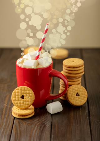 Marshmallows in a Cup with cookies with hearts out of the jam.の写真素材