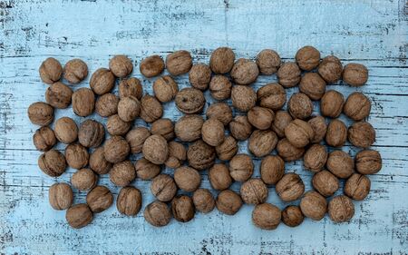 Walnuts on an old wooden background of blue color. Selective focus.の写真素材