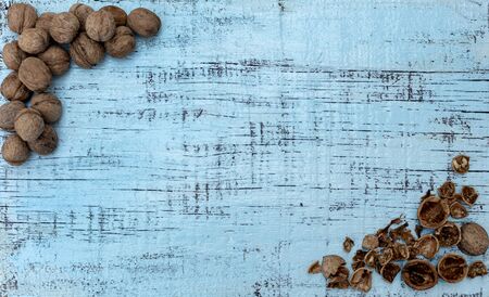 Walnuts on an old wooden background of blue color. Selective focus.の写真素材