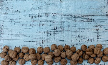 Walnuts on an old wooden background of blue color. Selective focus.の写真素材
