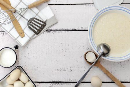 Cooking dough for pancakes. Rustic style, vintage utensils for the kitchen. Selective focus.