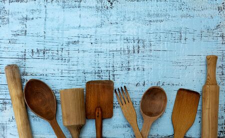 Vintage old kitchen utensils on a blue wooden