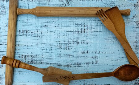 Vintage old kitchen utensils on a blue wooden background. Selective focus.