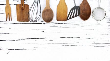 Vintage old kitchen utensils on a white wooden background. Selective focus.の写真素材
