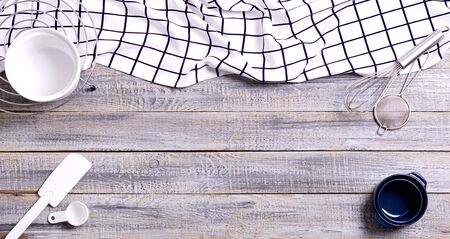 Kitchen utensils, cotton white checkered napkin on old wooden