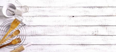 Kitchen utensils, cotton white checkered napkin on old wooden background. Selective focus.