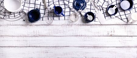 Kitchen utensils, cotton white checkered napkin on old wooden background. Selective focus.