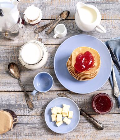 Tasty breakfast. Pancakes with strawberry confiture and butter. Selective focus.の写真素材