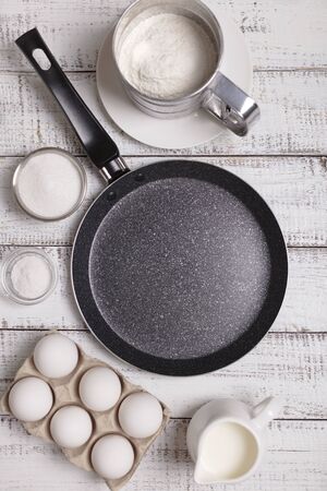 Cooking pancakes. Shrovetide (Maslenitsa) - blini stack on a blue plate on a wooden table. Selective focus.の写真素材