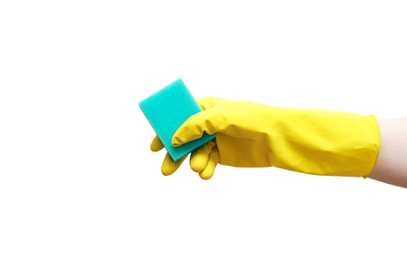 A hand in yellow rubber gloves holds a turquoise sponge for cleaning. A white isolate. Close-up.の写真素材