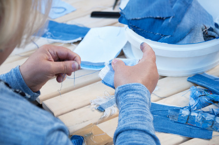 The woman makes ornaments from textiles. Close-up.の写真素材