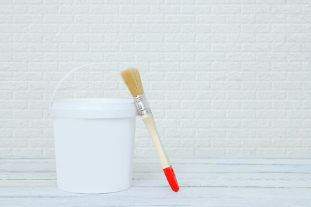 Pail with paint and paintbrush for painting at home.の写真素材