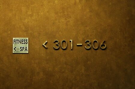 Golden wall in the hotel with signs and rooms.の写真素材
