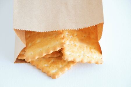 Cracker cookies in a craft package close-up on a white background.の写真素材