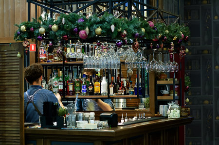 Russia 12-20-2018. A male bartender at work at the bar with alcohol.のeditorial素材