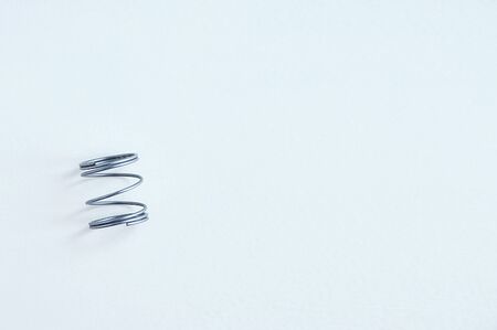 Metal spring close-up on a white background. View from above.の写真素材