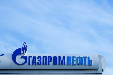 Russia 09-25-2019. Gas station sign on a background of blue sky. Russian text Gazpromneft.のeditorial素材