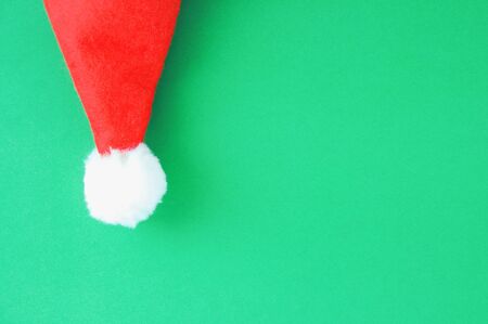 Christmas red Santa hat close-up on a green background.の写真素材