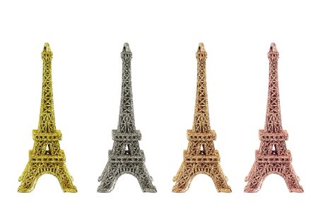 Four shiny figurines of the Eiffel tower in different colors. White isolate.の写真素材
