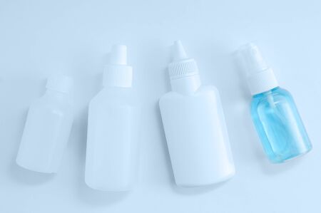 Closeup of four hand sanitizers in a plastic bottle on a white background.