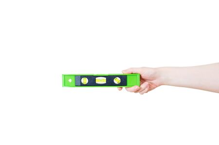Construction bubble plastic level in the hand of a caucasian woman. White isolate.