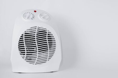 White electric fan heater close-up on a white background.の写真素材