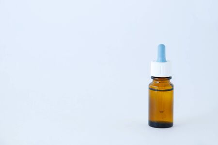 Nasal drops with a brown glass bottle on a white background. Place for text.の写真素材