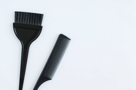 Hairdressing tools. Plastic black comb and brush for coloring hair on a white background.の写真素材