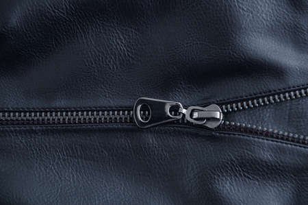 Zipper metal lock on a black leather boot close-up.の写真素材