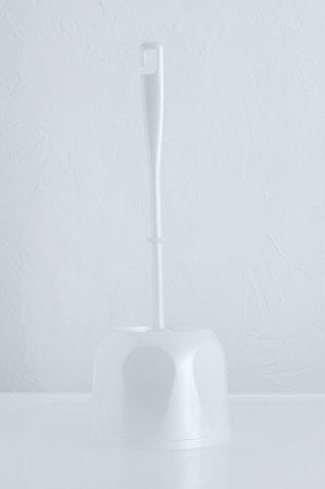 White brush brush for cleaning a toilet bowl on a stand. White background.の写真素材