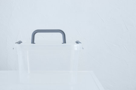 Transparent plastic box with lid for storage container on the table. White background.の写真素材
