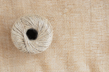 A skein of jute rope on a background of brown matting fabric.の写真素材