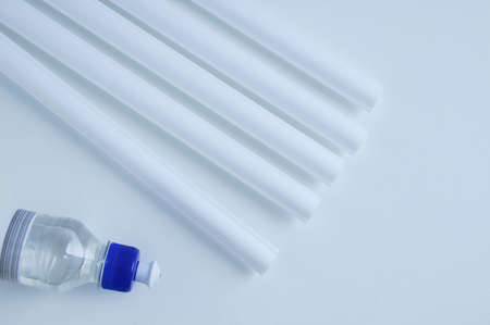 White wall molding and transparent glue tube. Home improvement. White background.