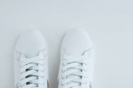 White sneakers with laces on a white background. View from above.の写真素材
