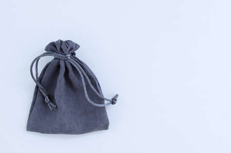 Gray fabric bag with ties close-up on a white background. Place for your text.の写真素材