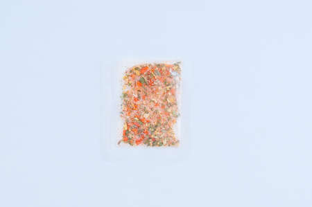 Seasoning for food in a transparent bag close-up on a white background.の写真素材