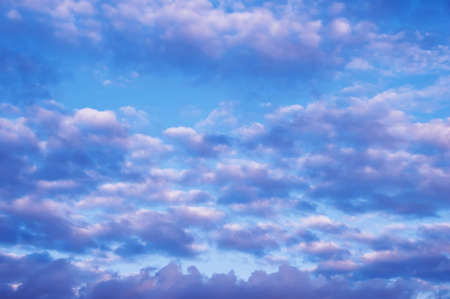 Cloudy skies in blue and pink. Heavenly background.