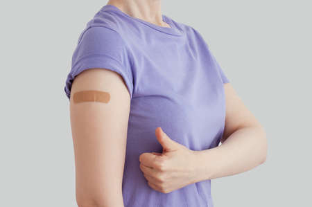 The hand of a Caucasian woman is sealed with a medical plaster on the forearm. The hand gesture is excellent.の写真素材