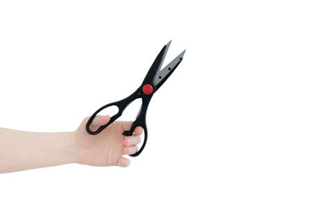 Stationery scissors in the hand of a caucasian woman. white isolate.