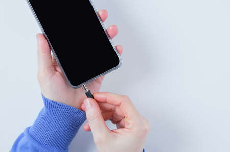 Connect to 3.5mm jack port of smart phone. white background.