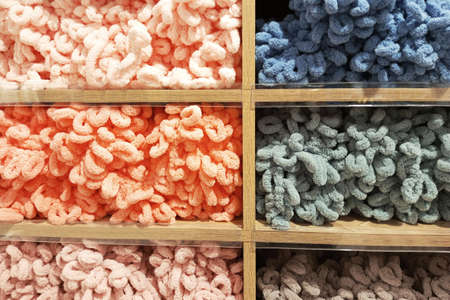 Soft bulk multi-colored yarn on the counter in the store.