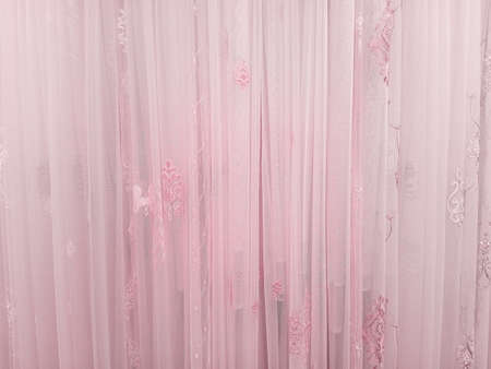 Pink tulle curtains with pattern. background texture.の写真素材