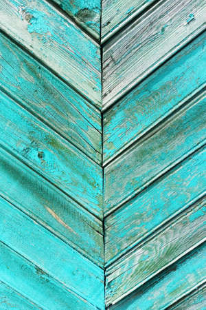 Green weathered boards with peeling paint. background texture.