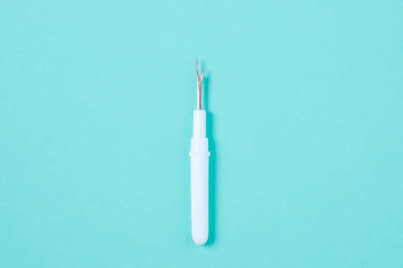 thread ripper. sewing tool. Turquoise background.の写真素材