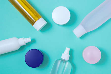 Lotion bottles and face cream jars. Turquoise background. view from above.の写真素材