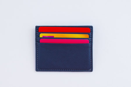 Credit bank cards in a gray business card holder. white background.