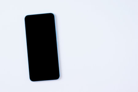 Smartphone with a black display on a white background. Place for text. view from above.