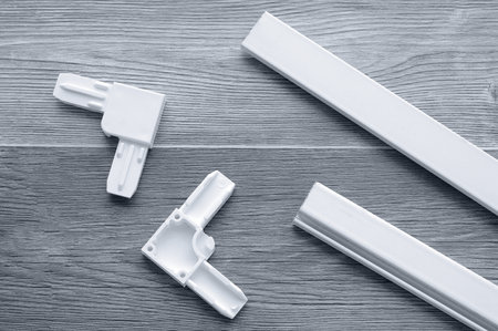 White plastic corners. Connection of a metal profile for a mosquito net.