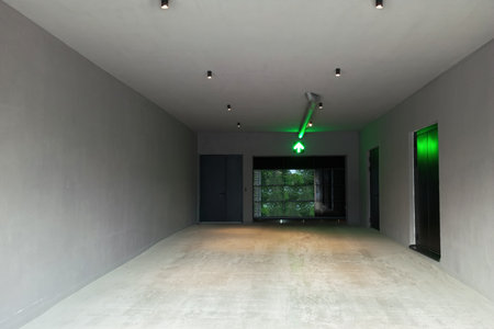 Entrance to the building with mirrored doors along the outer corridor. Green arrow indicates the...